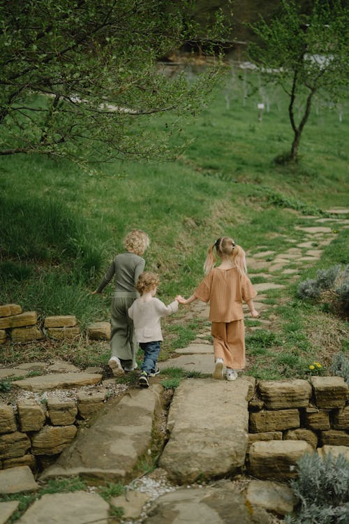 Kids Walking on Rocky Pathway