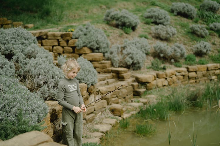 A Kid Holding A Stick 