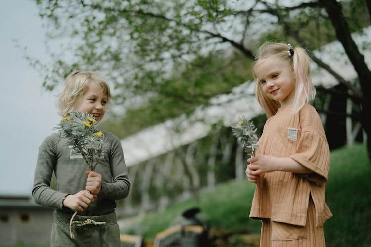 Kids Holding Flowers With Leaves