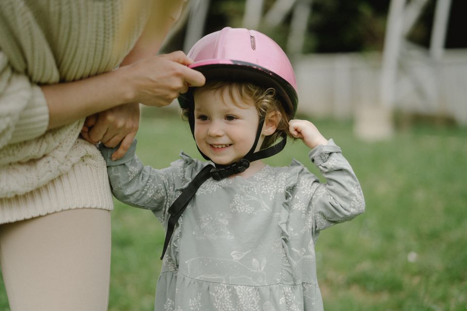 Child wearing a protective helmet