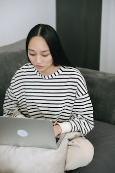 Woman working from home on a laptop, embodying the remote work lifestyle.
