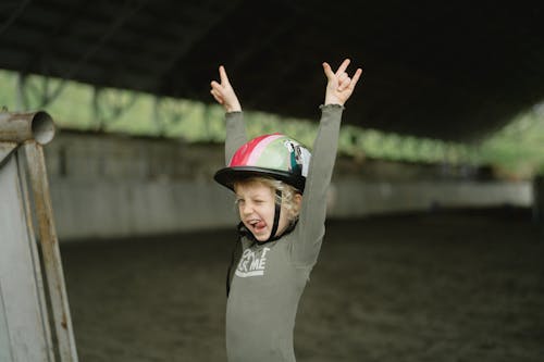 Girl in Gray Long Sleeve Shirt Raising Her Hands