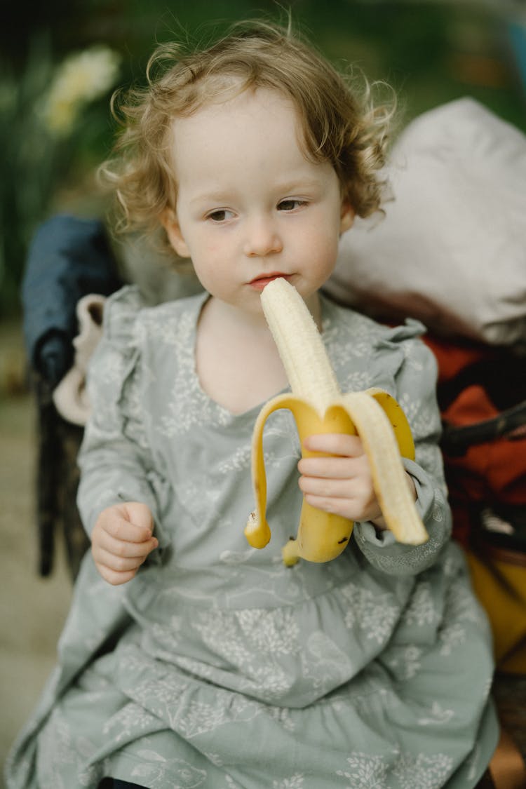 Young Girl Eating A Banana