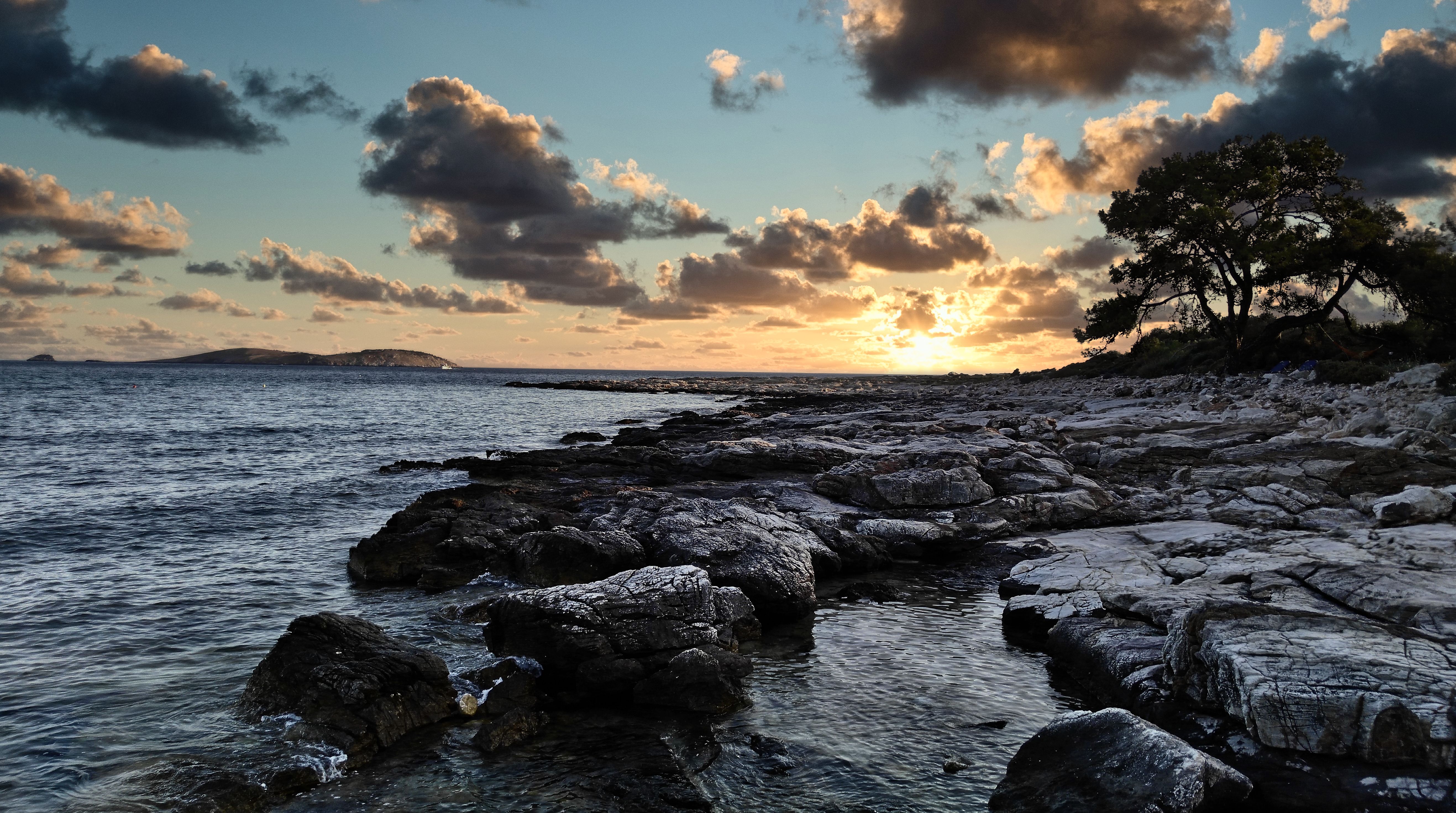 Brown and Gray Rocks on Seashore during Sunset · Free Stock Photo