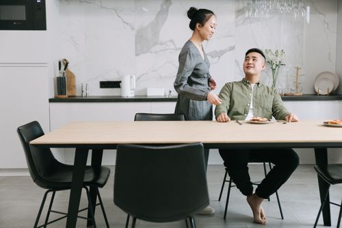 Free An Asian couple sharing a breakfast in their stylishly designed kitchen, conveying warmth and togetherness. Stock Photo