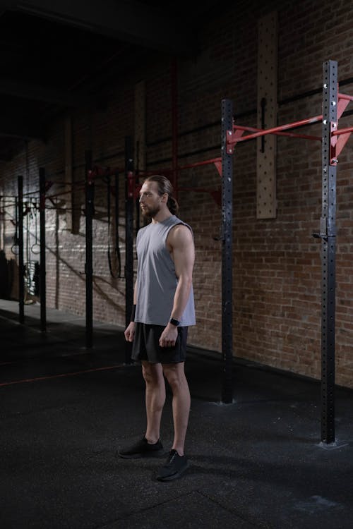 Free Man in Activewear Standing Inside the Gym Stock Photo