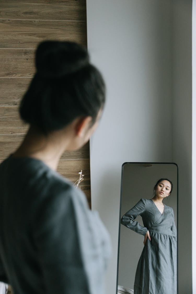 Woman Looking At A Mirror