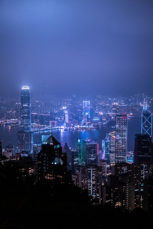 Free Stunning view of Hong Kong's illuminated skyscrapers reflecting over Victoria Harbour. Stock Photo