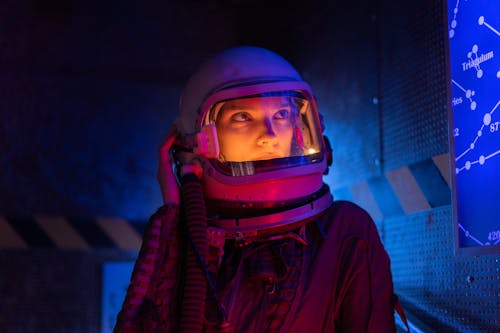 Free Person in Space Suit Looking At A Screen Stock Photo