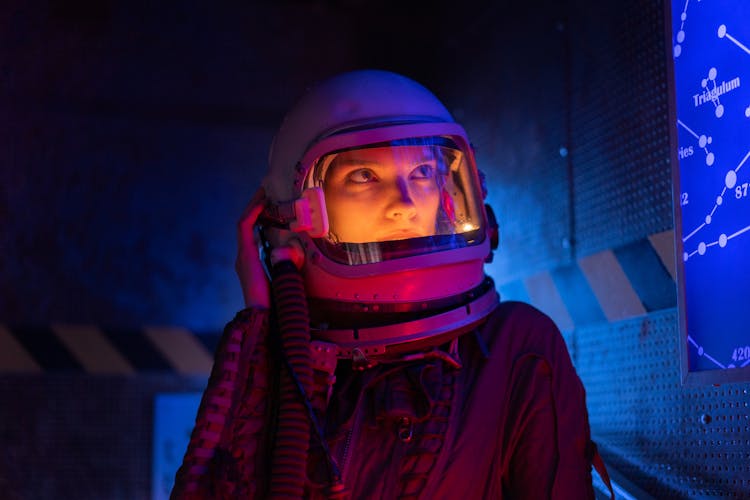 Person In Space Suit Looking At A Screen