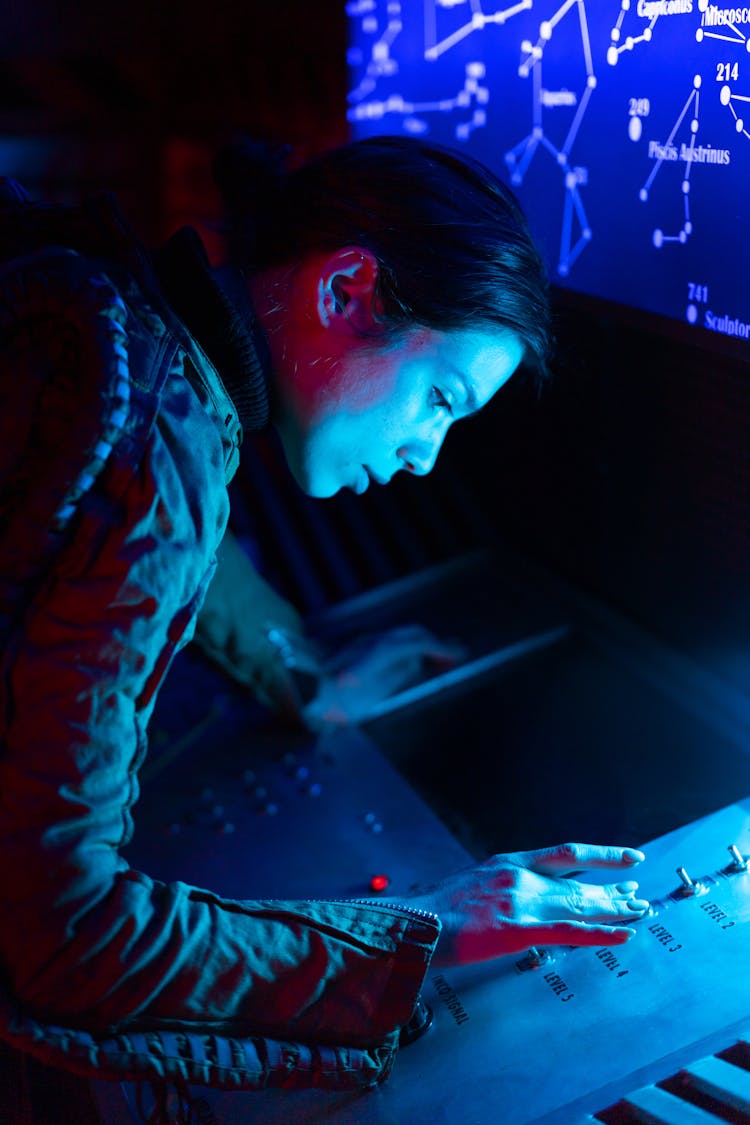 Woman In Spacesuit Touching A Control Panel