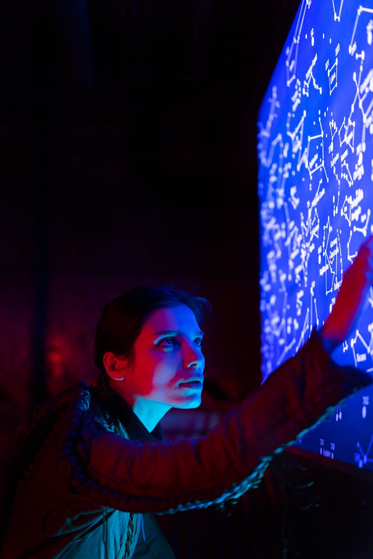 Woman In Spacesuit Touching A Screen 