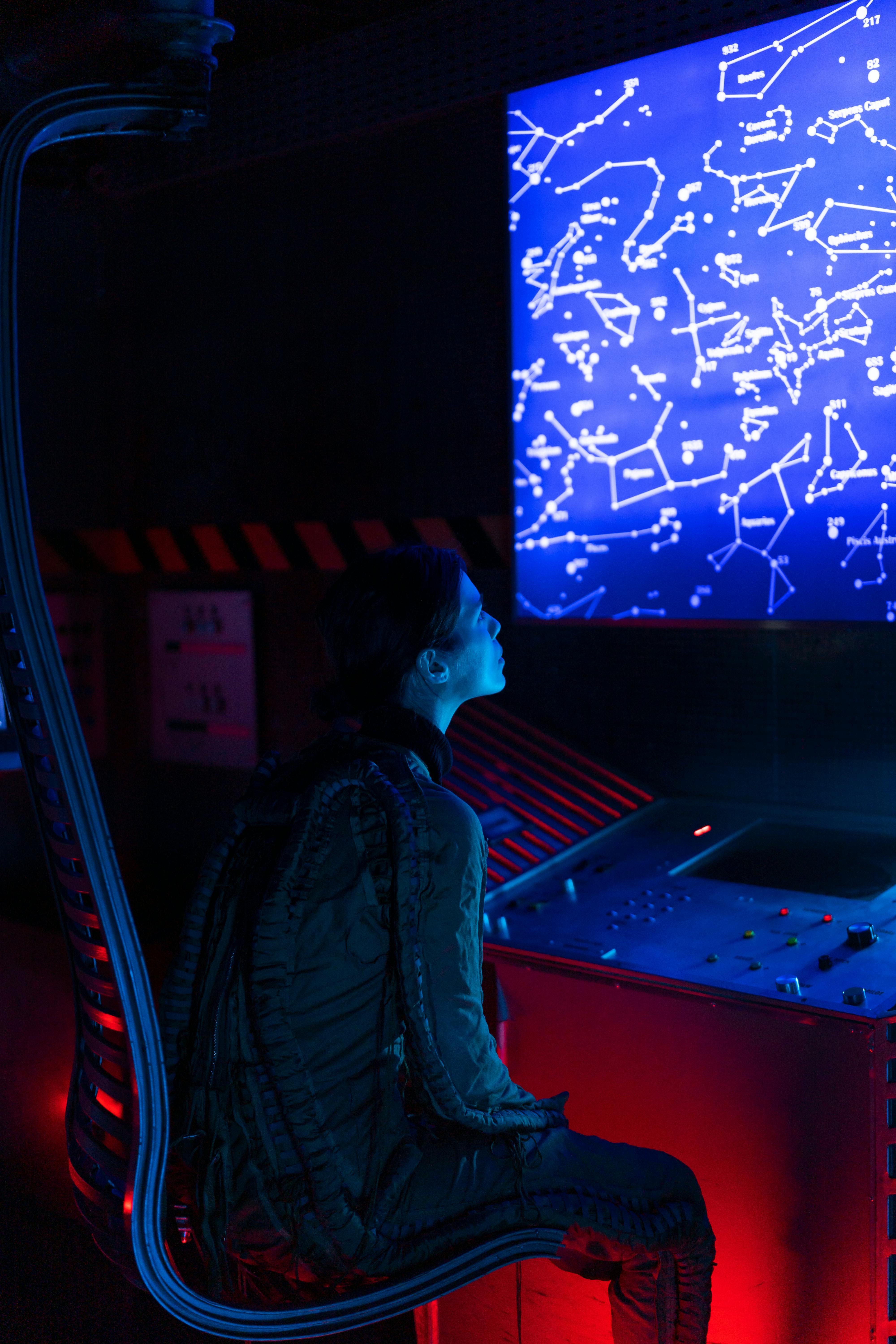 woman looking on a screen inside a spacecraft