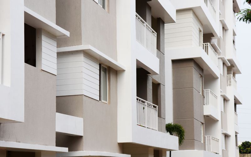 Modern residential building exterior with sculpted balconies, architectural design project