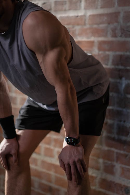 Man in Gray Tank Top and Black Shorts