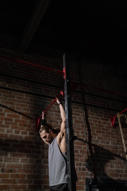 A Man Sitting Under the Pull Up Bar · Free Stock Photo