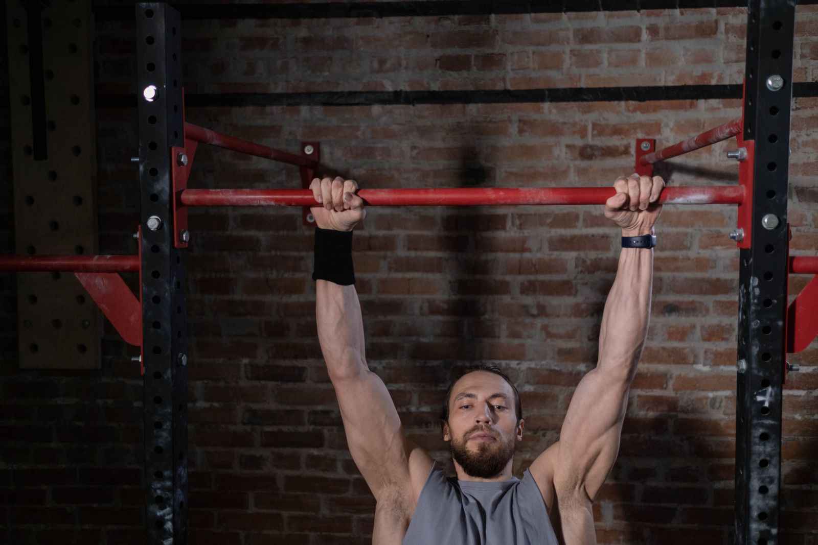 Person adjusting a wrist support during a bright home workout setting