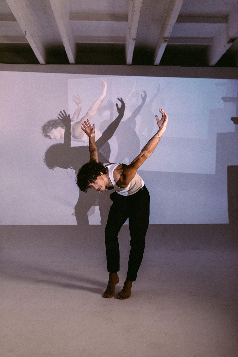 Modern dancer under studio projections