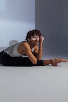 Flexible dancer in studio showcasing an elegant pose and self-expression.