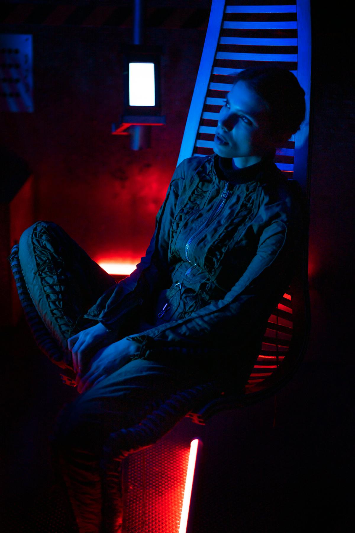 Music producer using a laptop and MIDI controller with digital audio workstation on screen