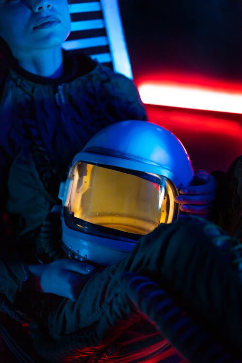 Crop Photo Of Woman Wearing A Spacesuit Sitting On A Metal Chair