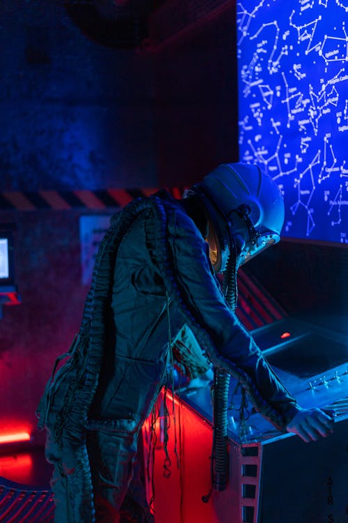 Woman In Spacesuit Looking At A Control Panel