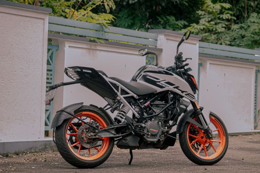 Motorcycle Parked Beside a Concrete Fence