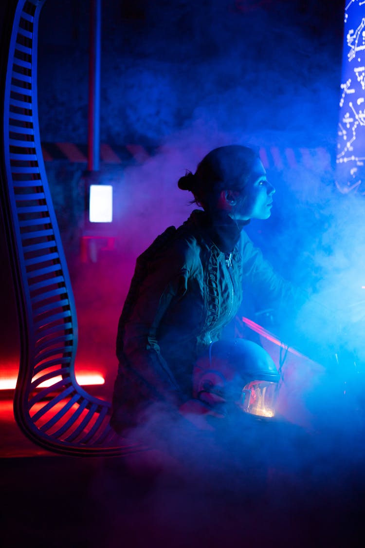 Woman Sitting Inside A Spacecraft With Smoke Around Her