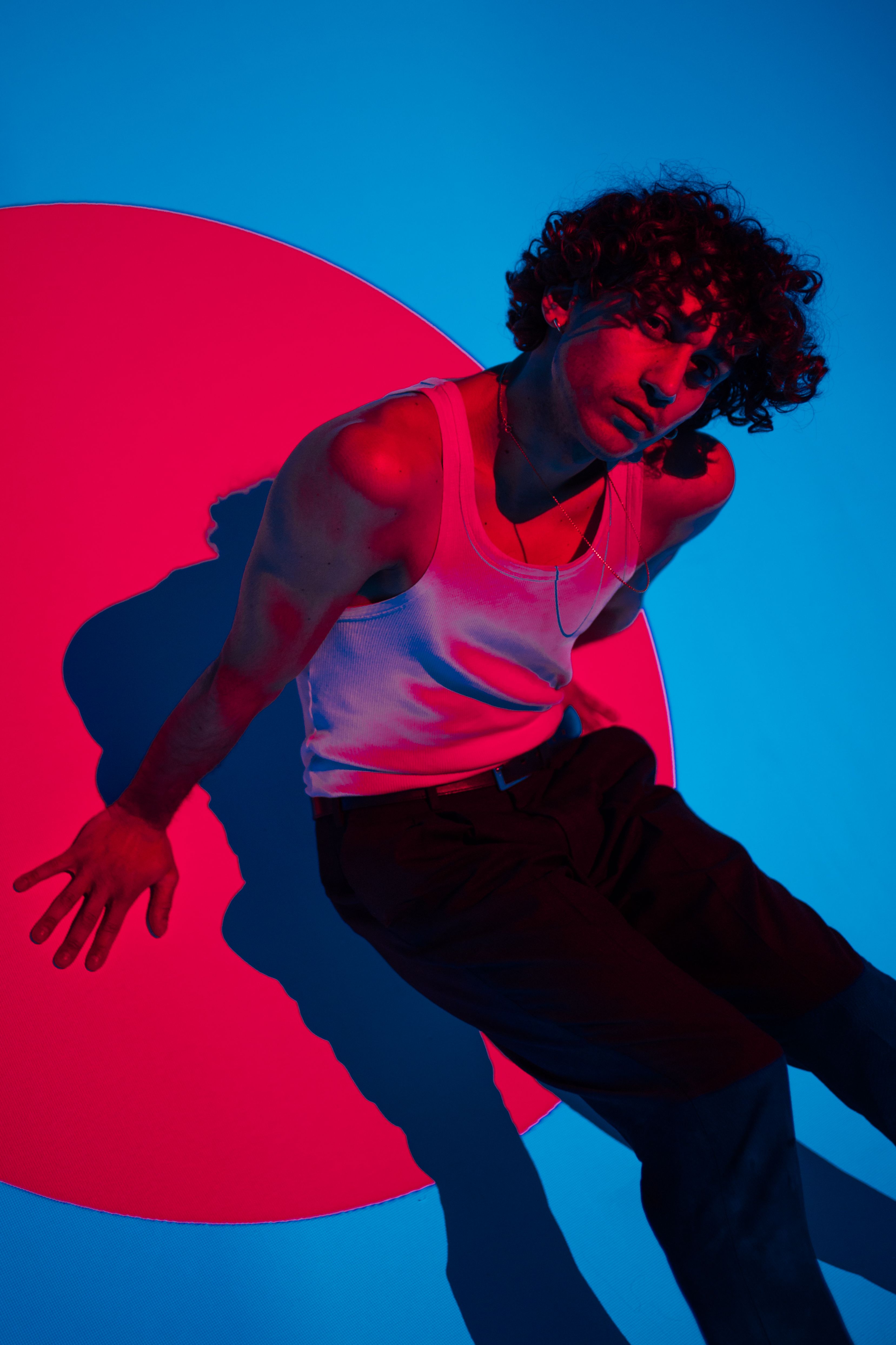 Vibrant photo of a young dancer with dramatic lighting and colorful background.