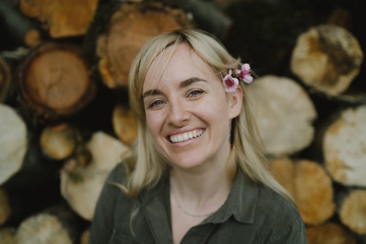 A Blonde Woman With Flowers On Her Ear 