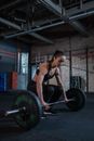 Woman in Black Sportswear Lifting a Barbell