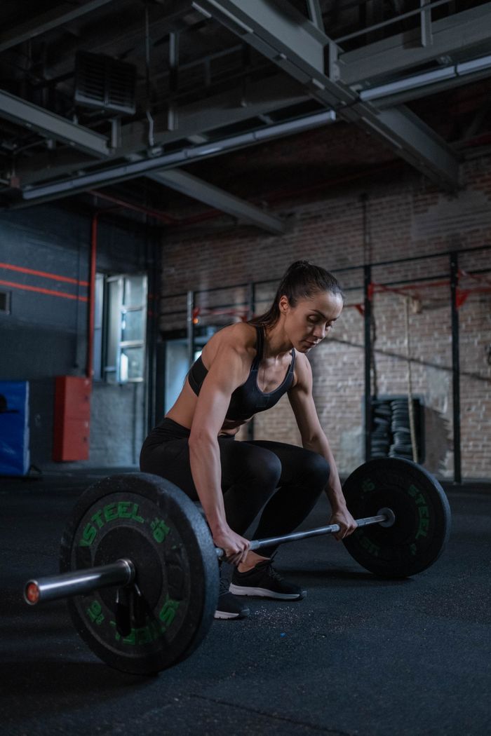 Athletes training with barbells in a group session