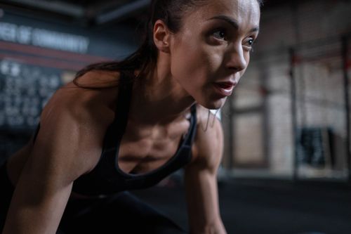 Free Close-up of a determined female athlete sweating during a workout session indoors. Stock Photo