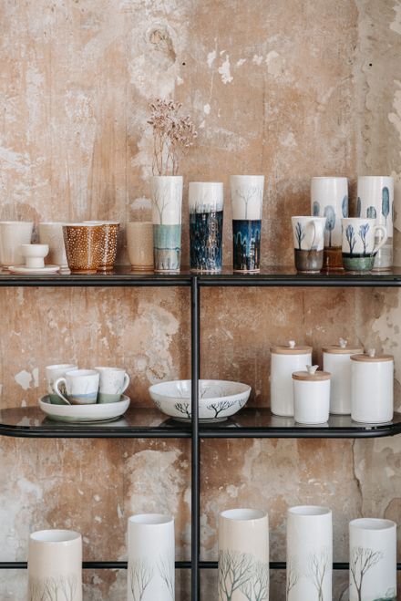 Handmade ceramic vases on rustic shelves — photo by Pavel Danilyuk on Pexels