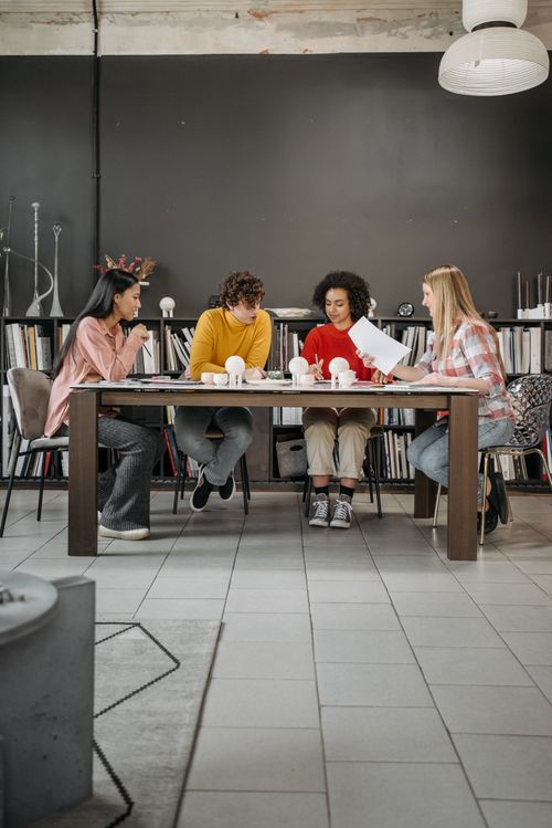 Free Diverse group brainstorming ideas in a creative office setting. Stock Photo