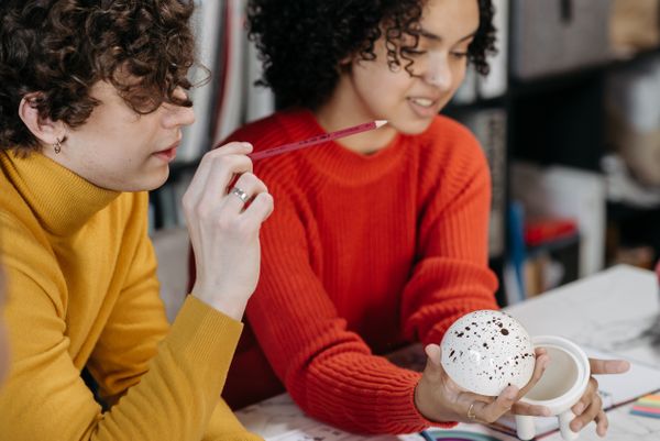 Two makers looking at a prototype — Pavel Danilyuk on Pexels