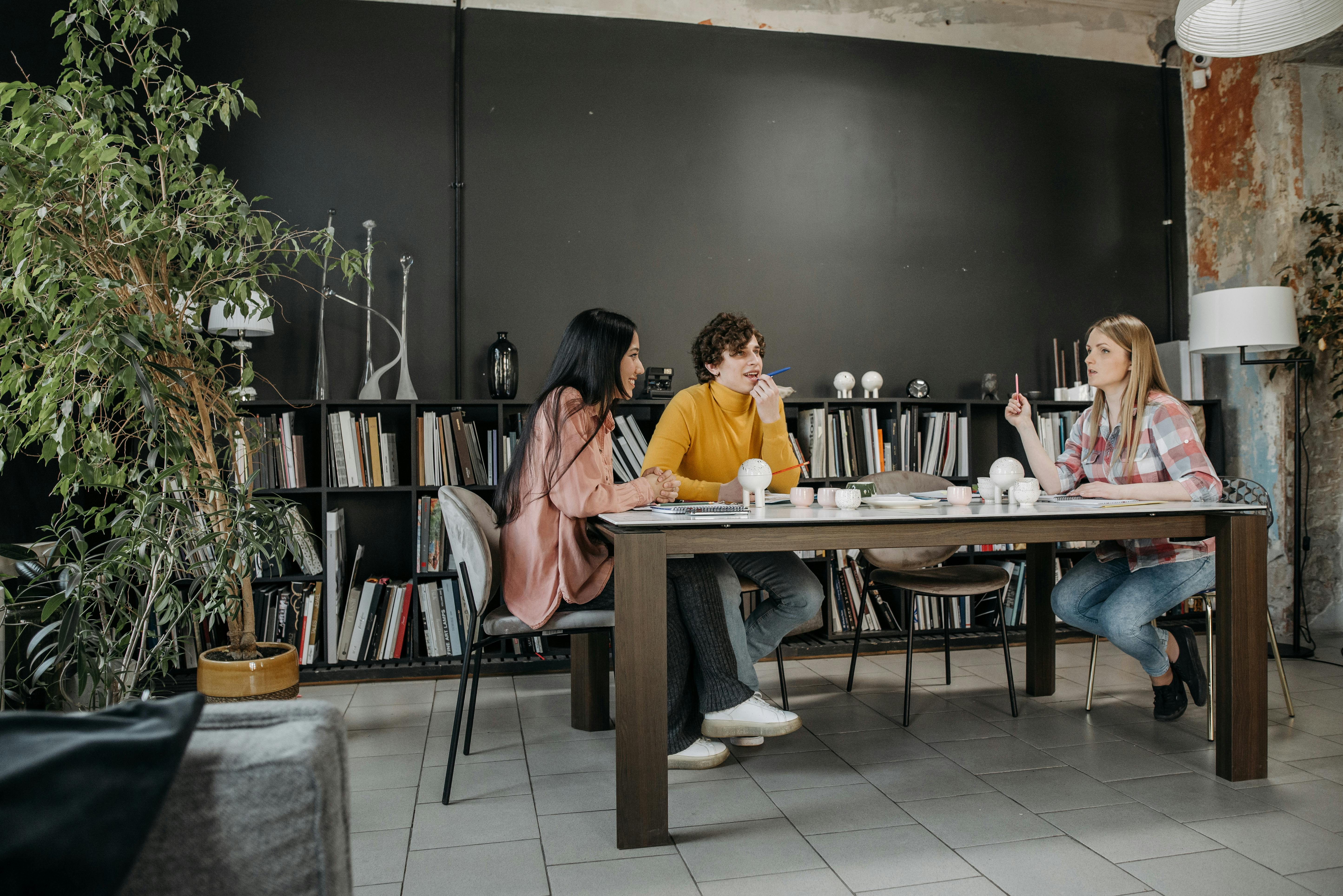 a group of people having a meeting in the office