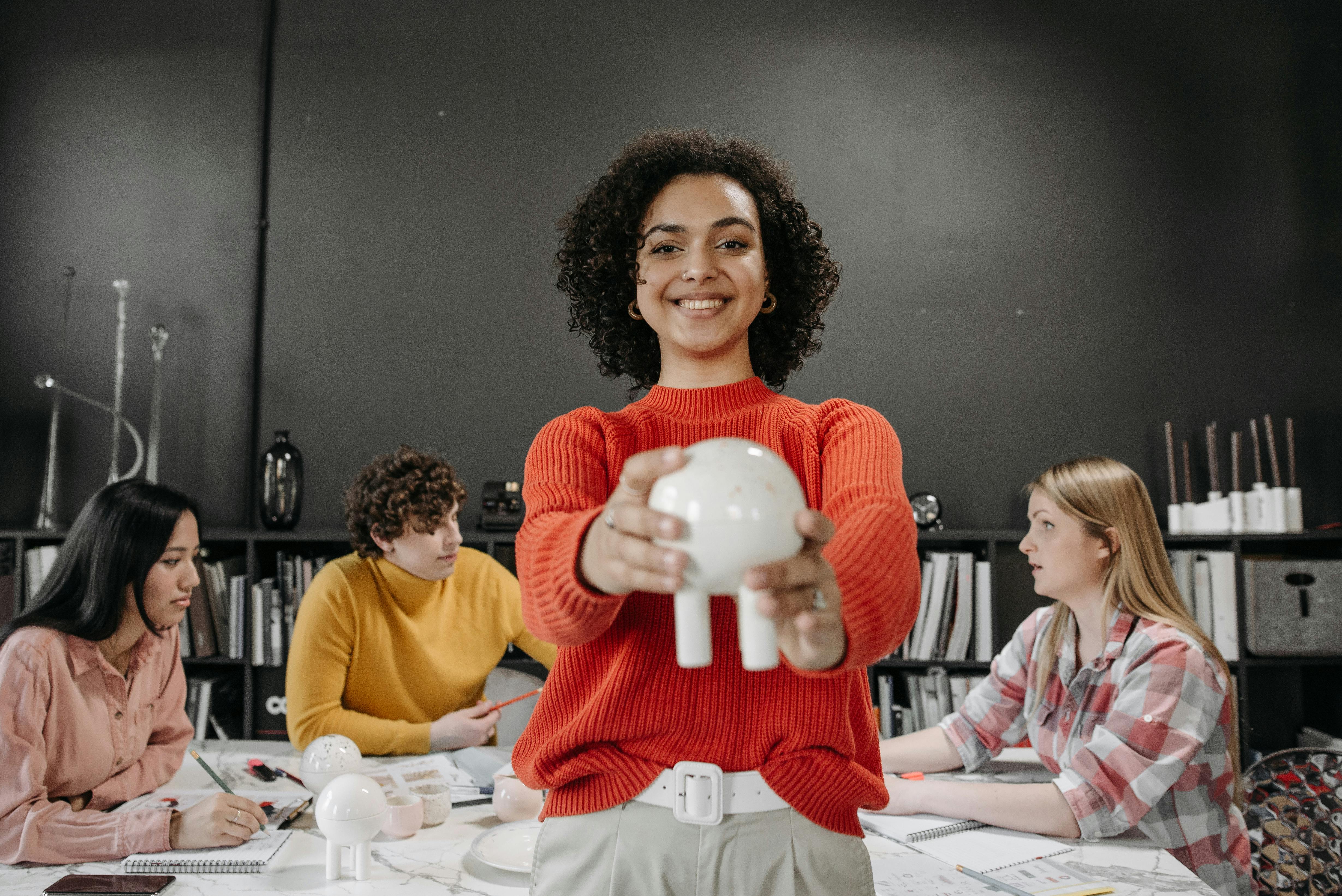 a woman holding ceramic product