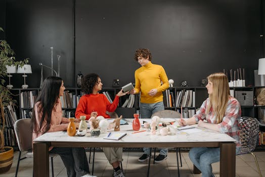 Diverse team discussing ideas at a table with ceramics in a modern office setting.