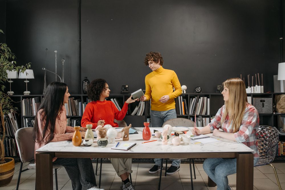 Photo by Pavel Danilyuk on Pexels — a team reviewing work together at a studio table
