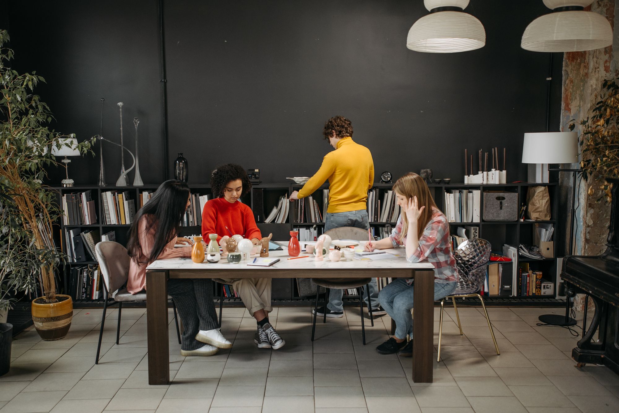 Astragal colleagues working together around a shared table in a converted warehouse studio. Photo by Pavel Danilyuk on Pexels