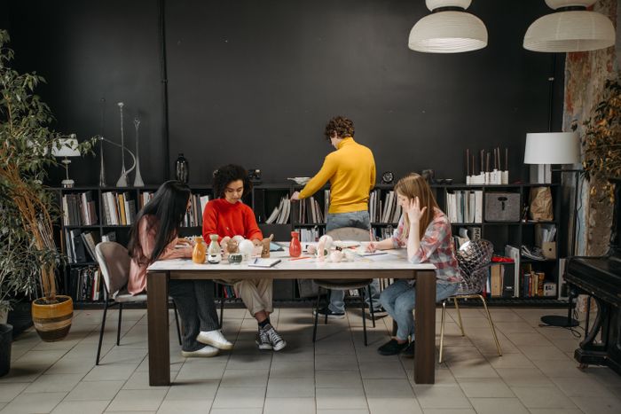 Members working together at a shared studio table — photo by Pavel Danilyuk on Pexels