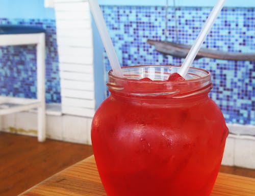 Red Beverage on Clear Glass Dispenser