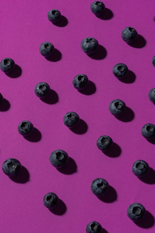Photo of Blueberries on Purple Surface