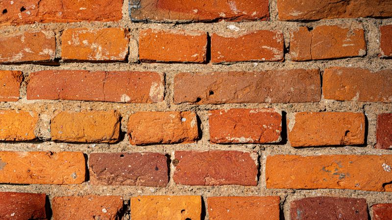 Close view of brick coursework with thick mortar joints