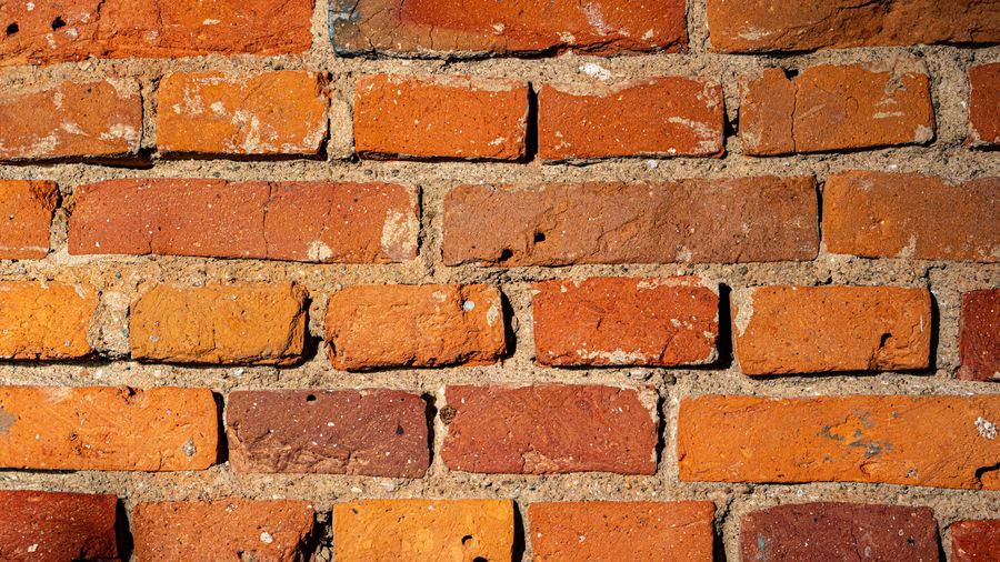 Close view of brick coursework with thick mortar joints