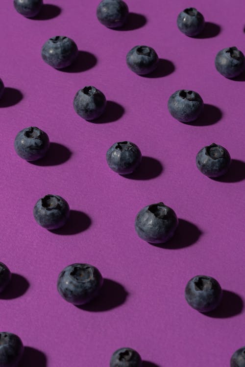 Blueberries over Purple Surface