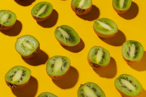 Sliced Kiwis on Yellow Surface