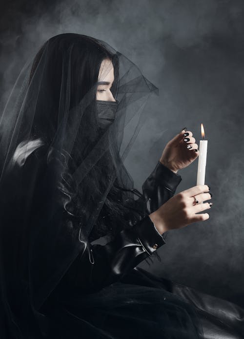 Woman in Black Hijab Holding Cigarette Stick