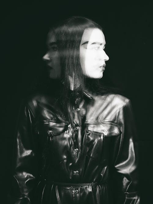 Grayscale Photo of a Woman in a Leather Jacket